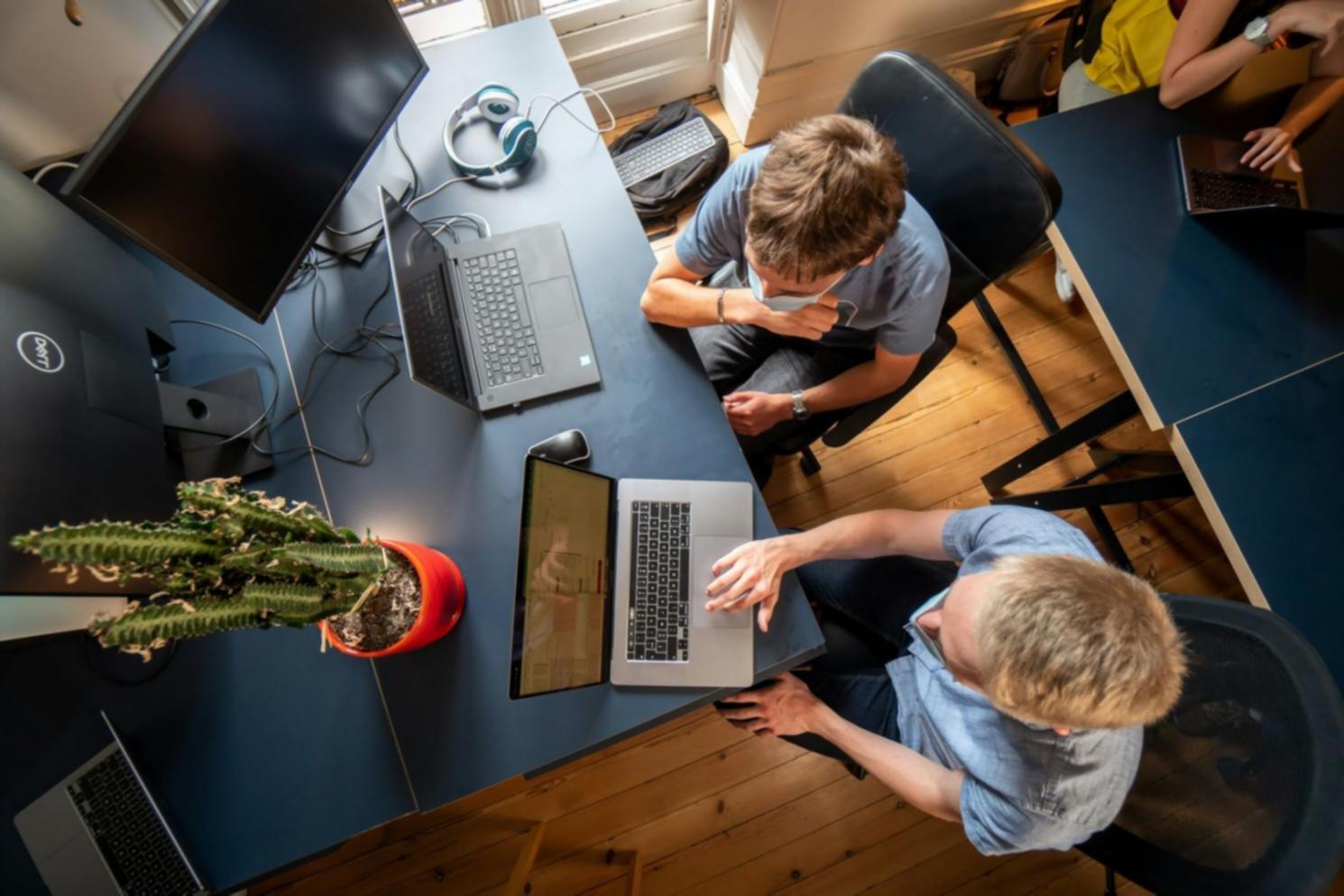Professional analyzing financial data and market trends on multiple monitors